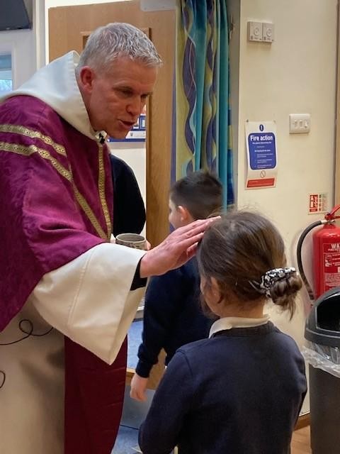 Fr Paul blesses a pupil