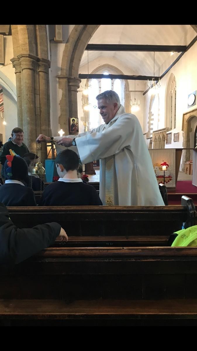 Fr Paul blesses the children with holy water...
