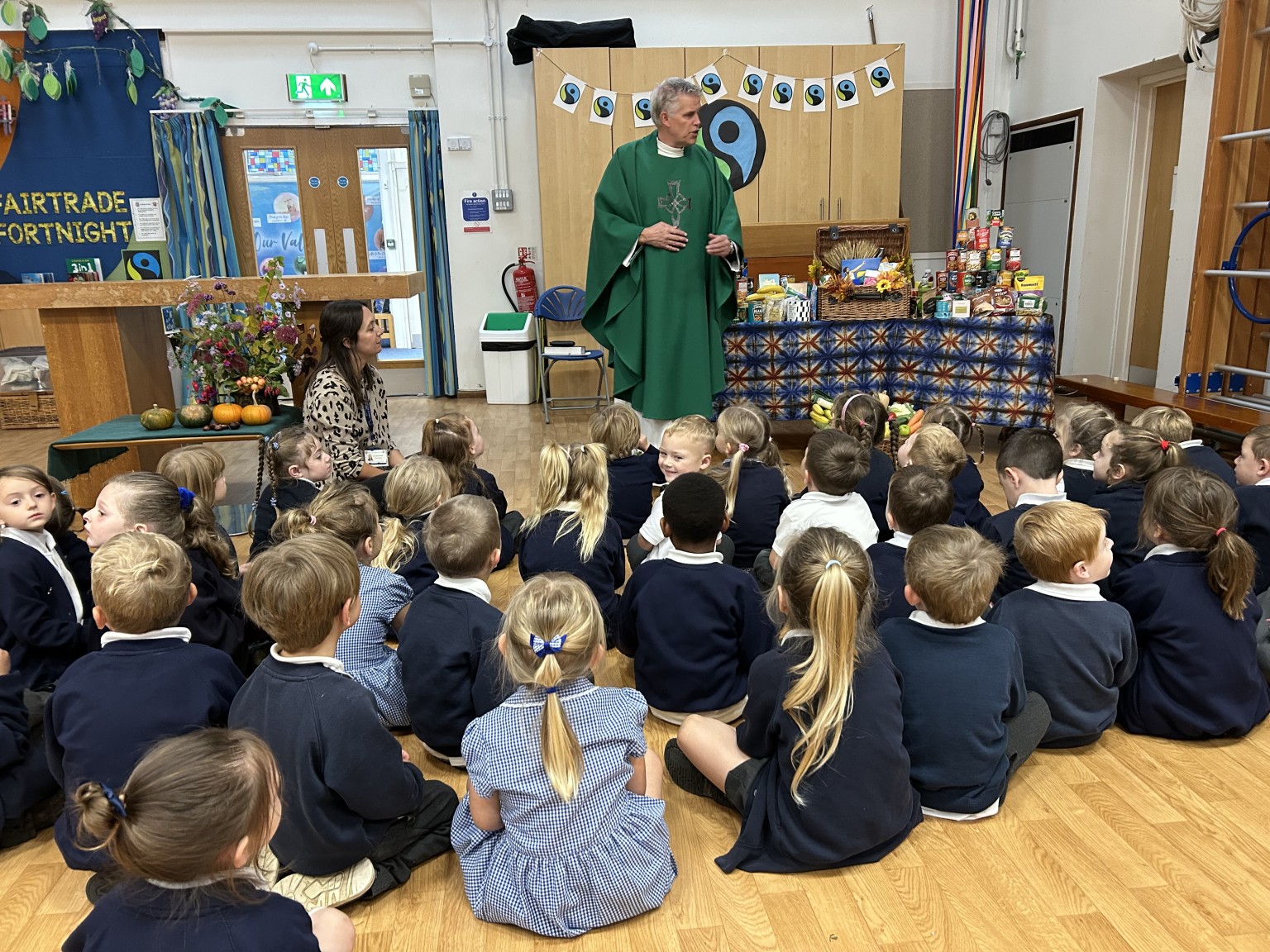 Fr Paul talking to the EYFS children about Harvest