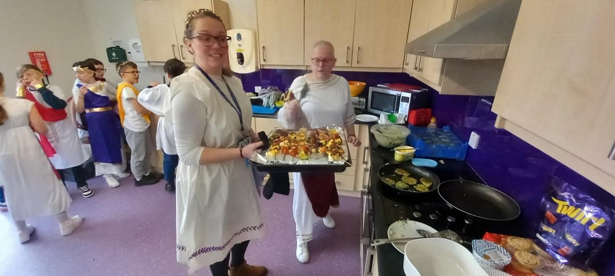 Mrs Bryan and Mrs Hayes cooking the (kolokithokeftedes) fritters and souvlaki (skewers)...