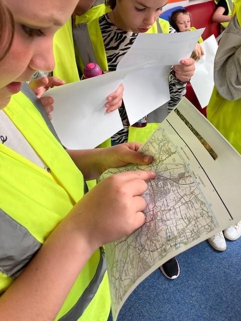 Map reading skills, looking at an ordnance survey map, plotting coordinates and looking for symbols of features. 