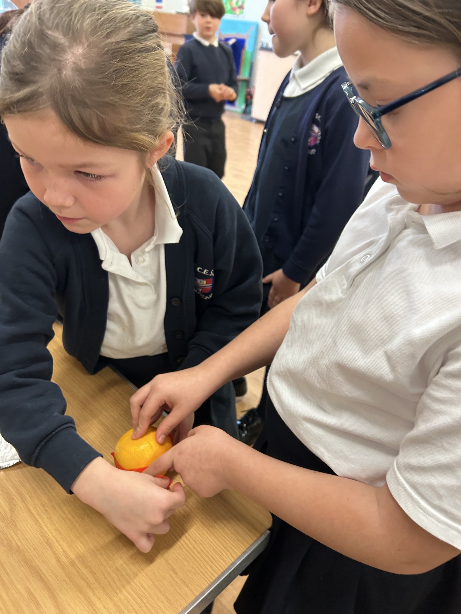 Our children buddy up to make Christingles