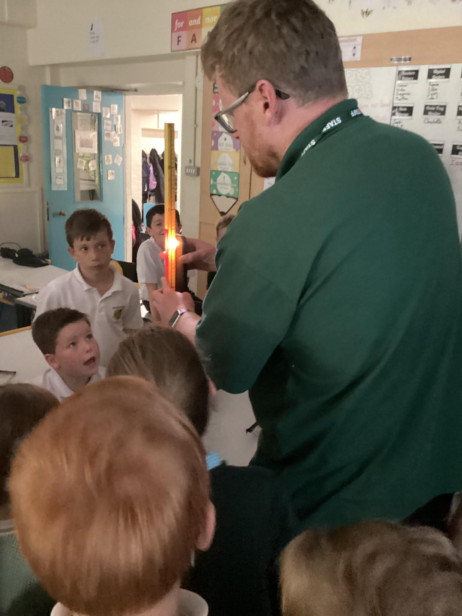 Pupils exploring how shadows move depending on where the light source is.
