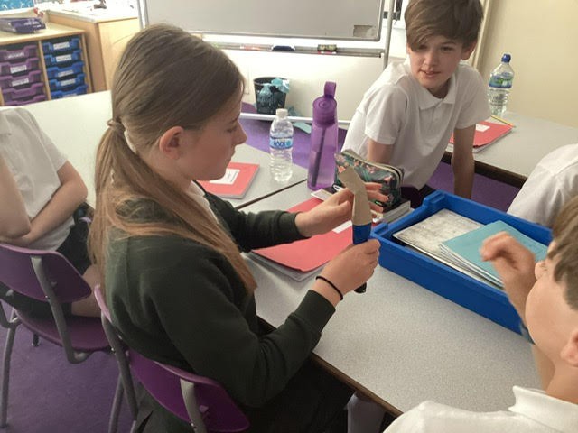 Pupils exploring how light travels.