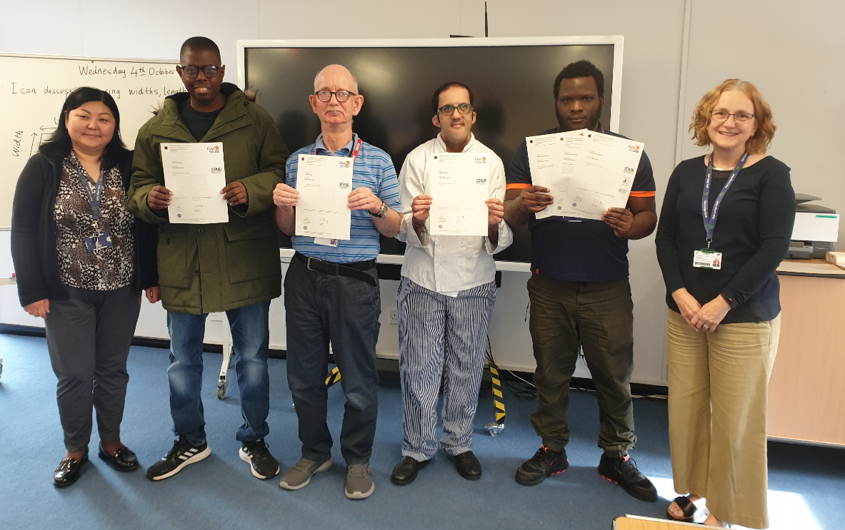 The adult learners receiving certificates 