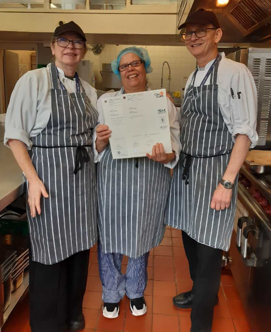 One of our learners, Maria receiving her certificate from teacher Paul and CSW Les