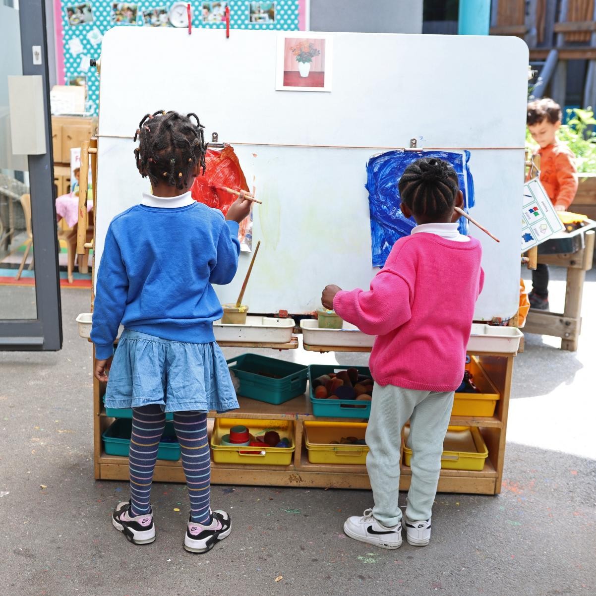 children painting outdoors