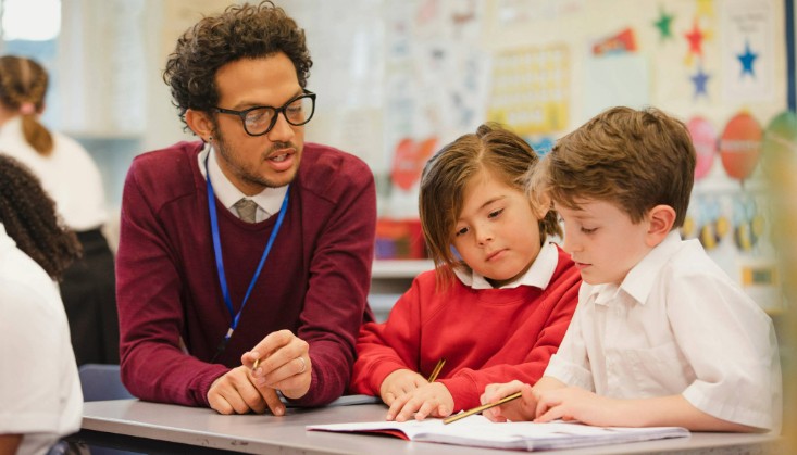 Teacher working with two pupils
