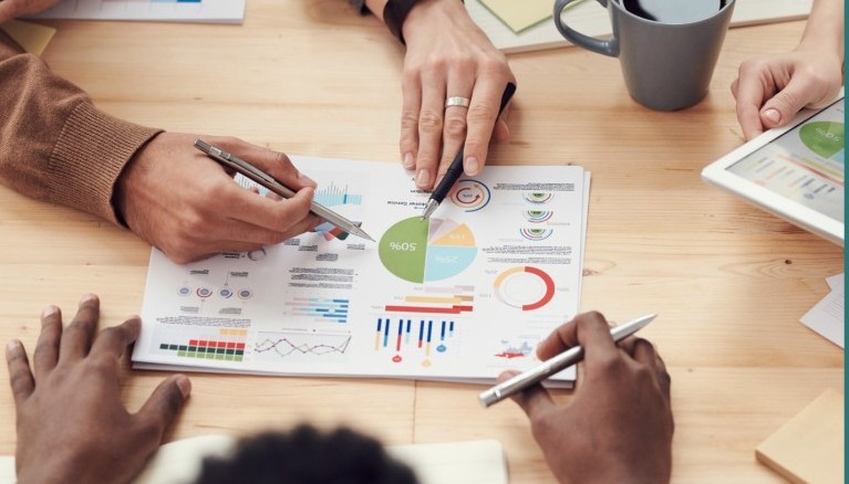 People around a document containing various charts