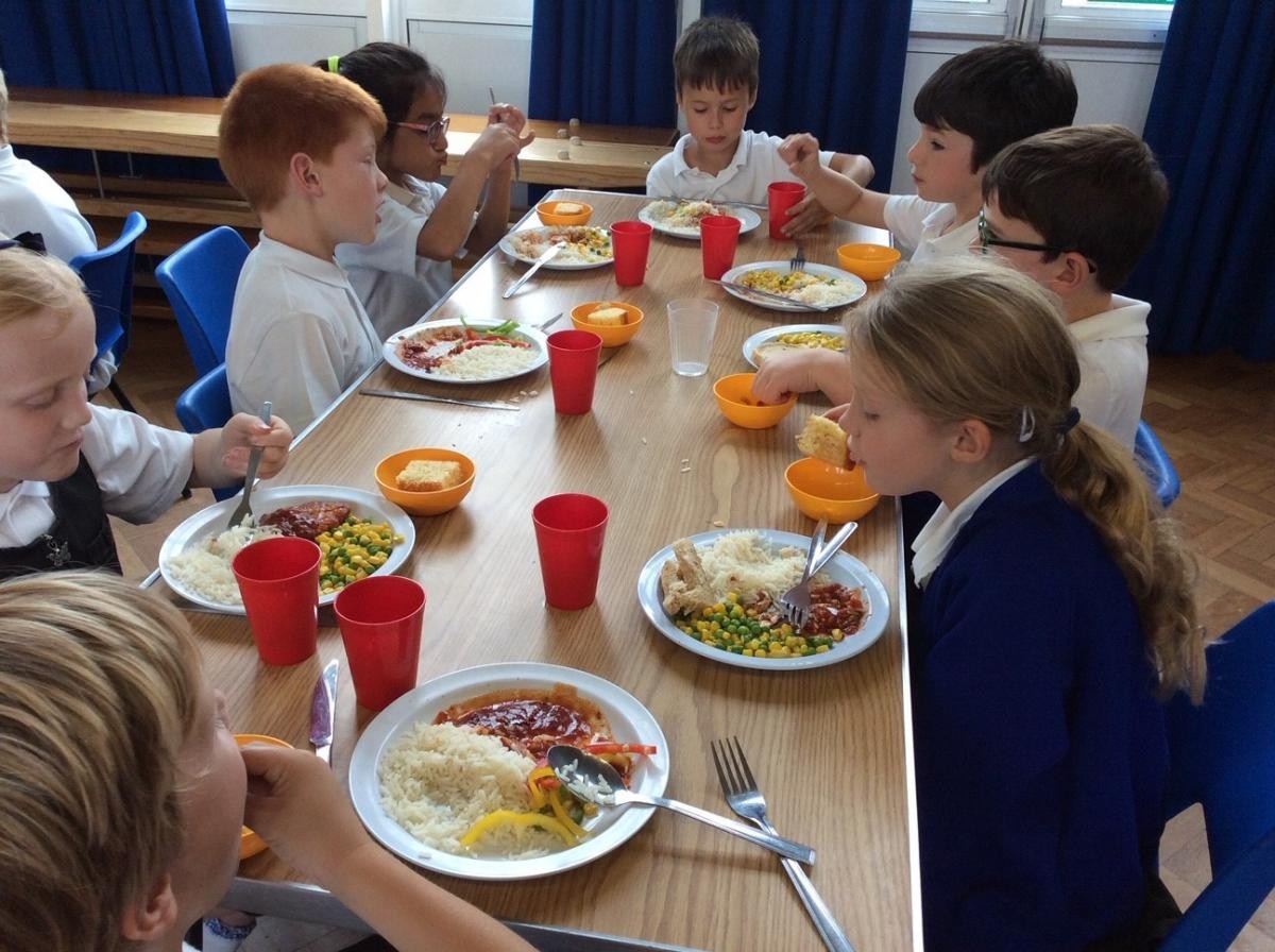 Key Stage 2 enjoying their cooked lunches.