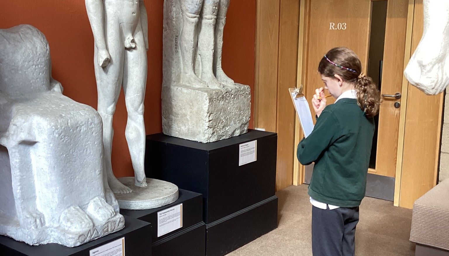 Taking time to study the statues and answering questions on what they depict.