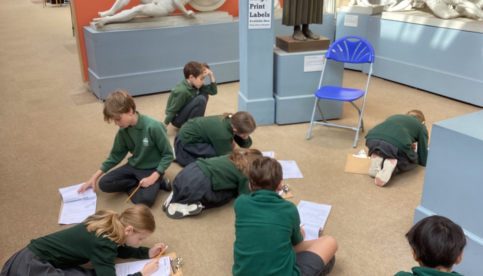 Taking time to study the statues and answering questions on what they depict.