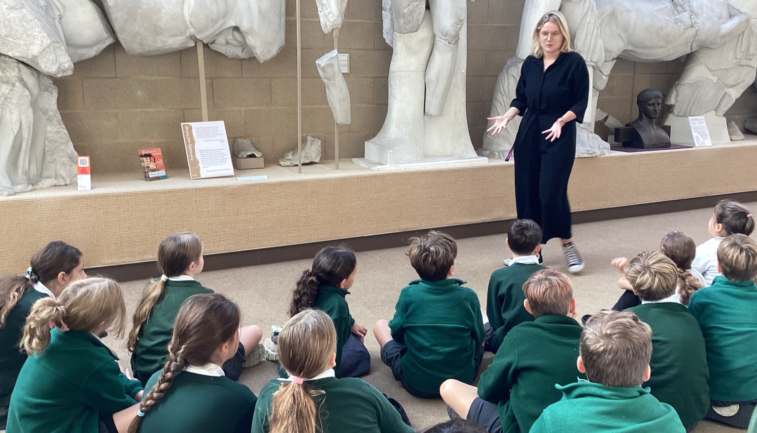 Taking time to study the statues and answering questions on what they depict.