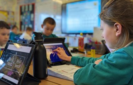 children learning on ipads 