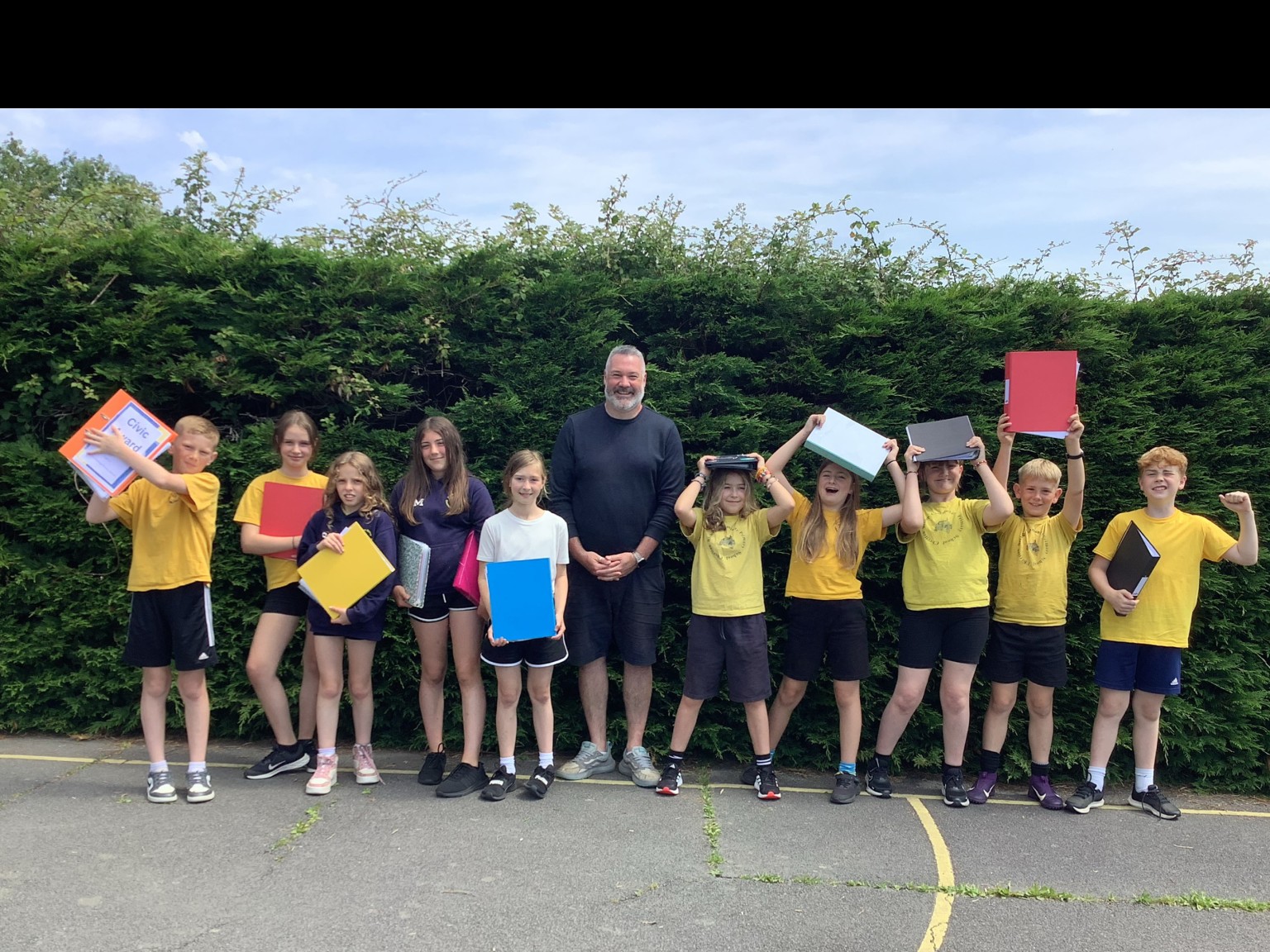 children stood on a playground with adult