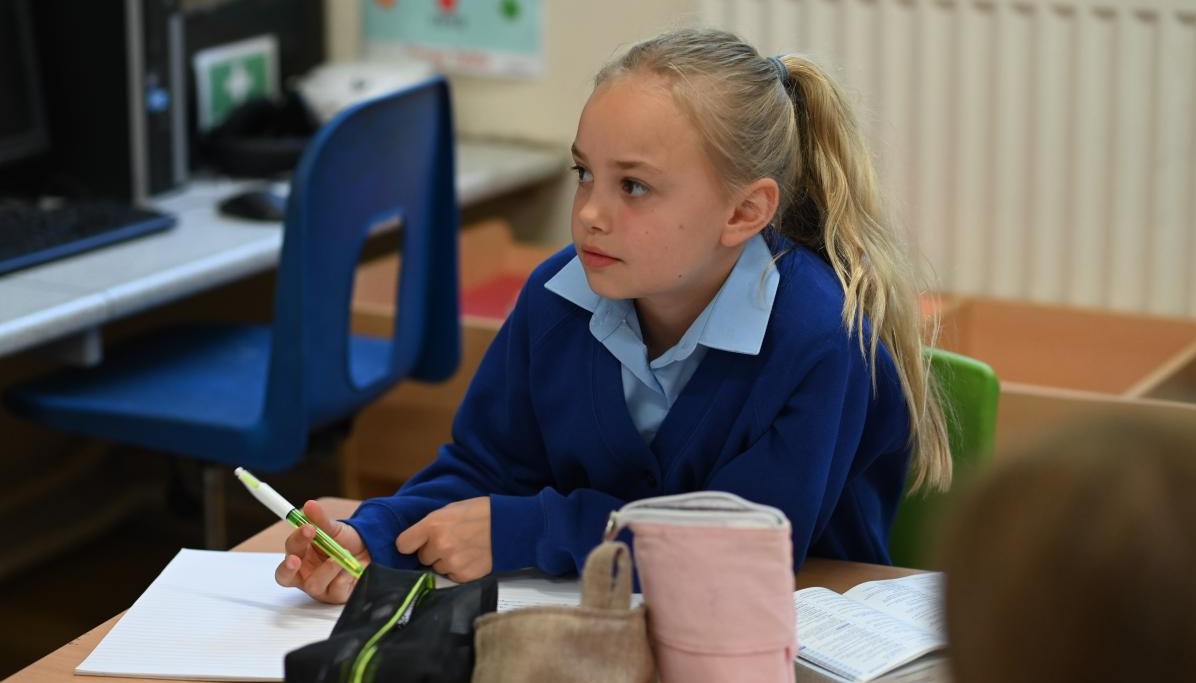 Child holding a pen