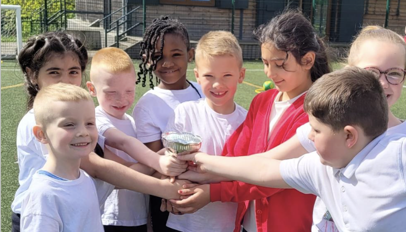group of children holding trophy